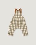 A baby romper in a beige and white gingham check pattern with brown shoulder straps, displayed flat against a light gray background.