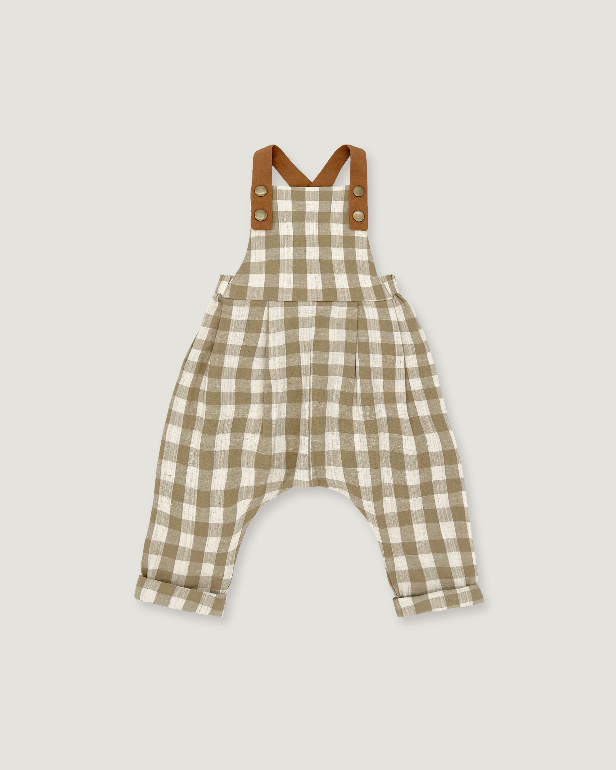 A baby romper in a beige and white gingham check pattern with brown shoulder straps, displayed flat against a light gray background.
