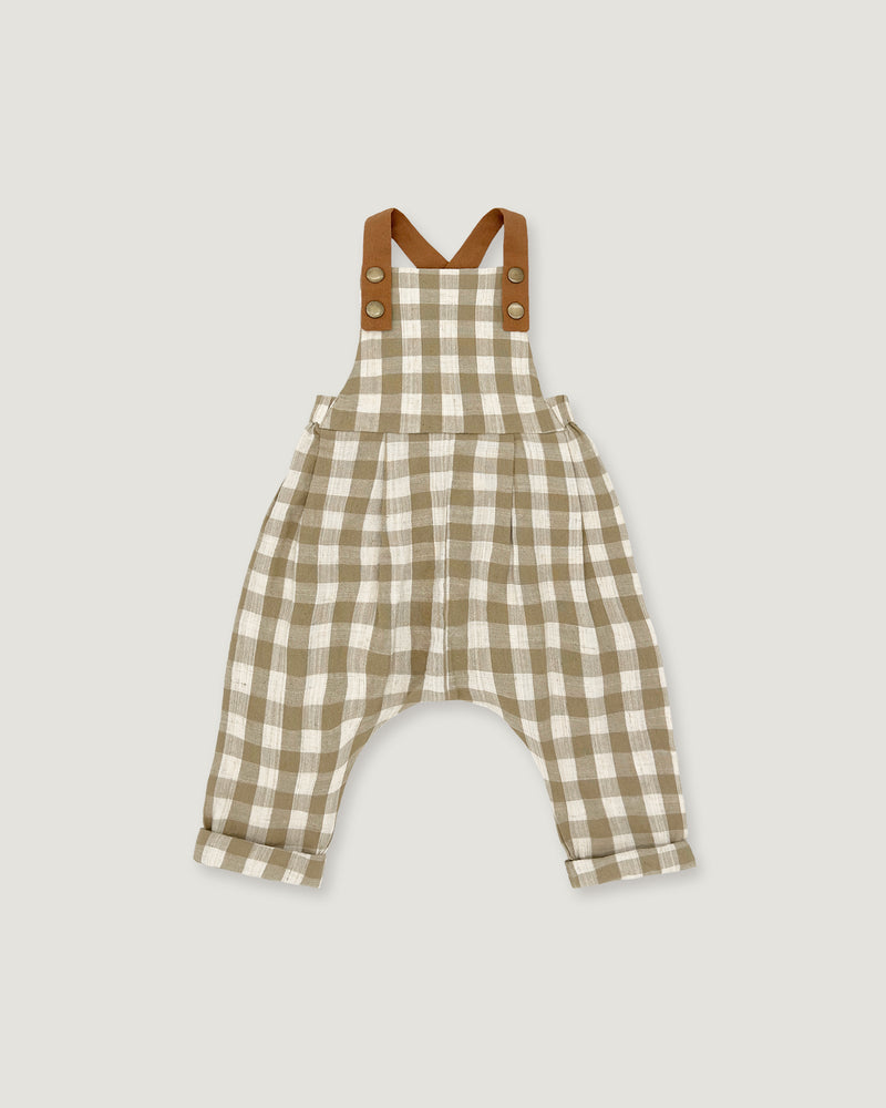 A baby romper in a beige and white gingham check pattern with brown shoulder straps, displayed flat against a light gray background.