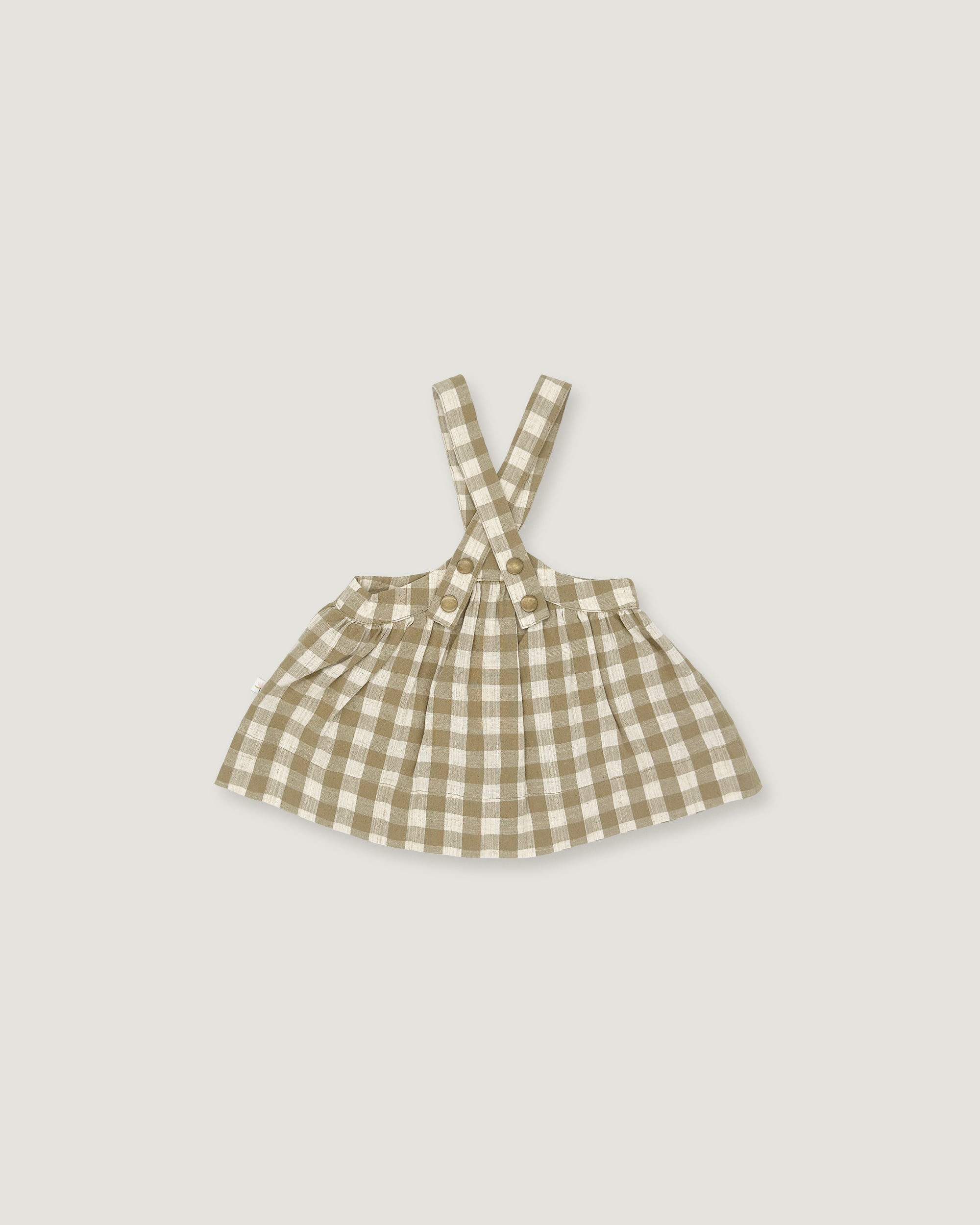 A small children's sleeveless dress with shoulder straps in a beige and white gingham check pattern, shown flat against a light gray background.