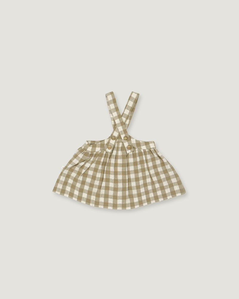 A small children's sleeveless dress with shoulder straps in a beige and white gingham check pattern, shown flat against a light gray background.