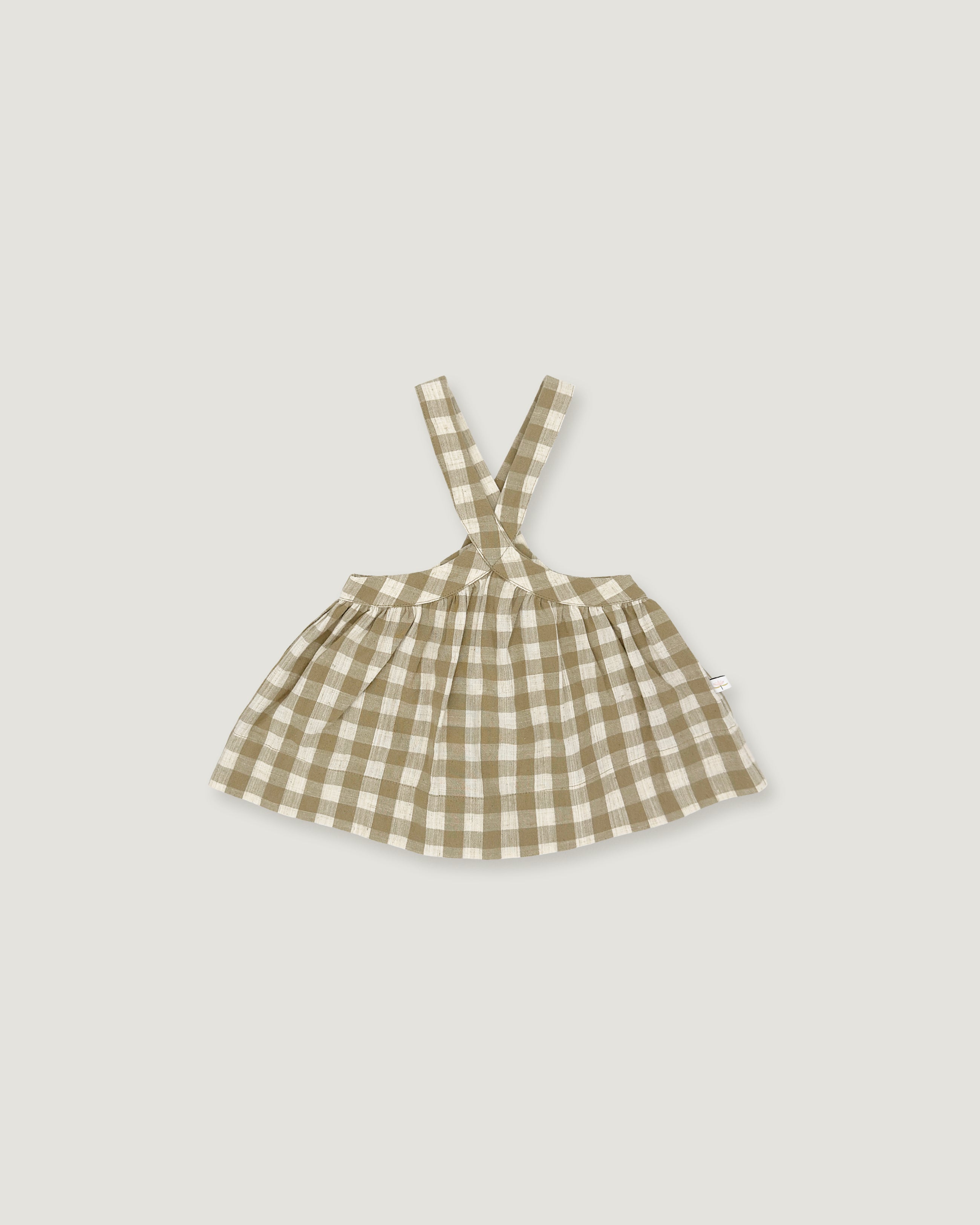 A small sleeveless dress with shoulder straps in a beige and white gingham check pattern, shown flat against a light gray background.