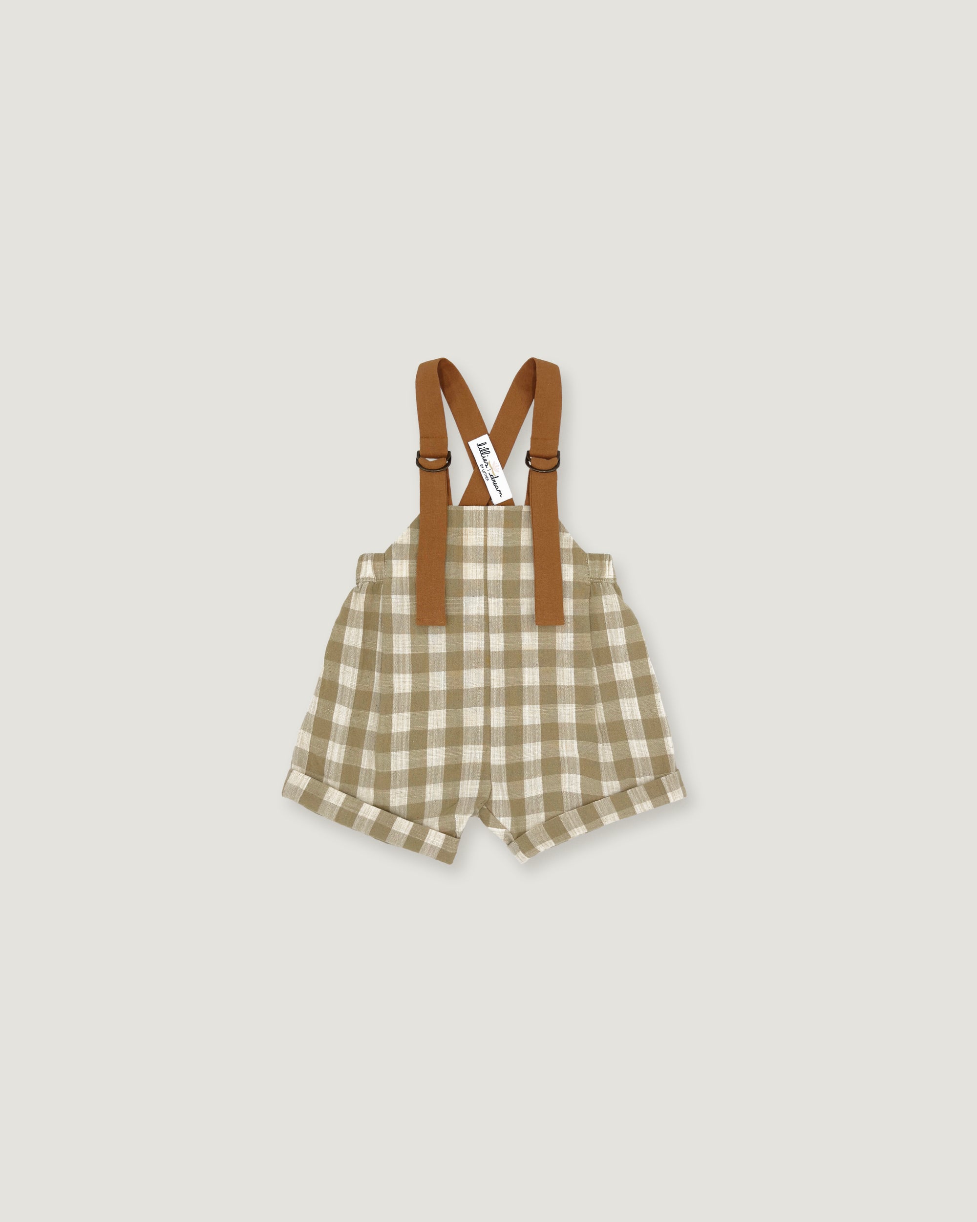 A baby romper with brown suspenders, featuring a beige and white gingham check pattern, shown flat on a light gray background.