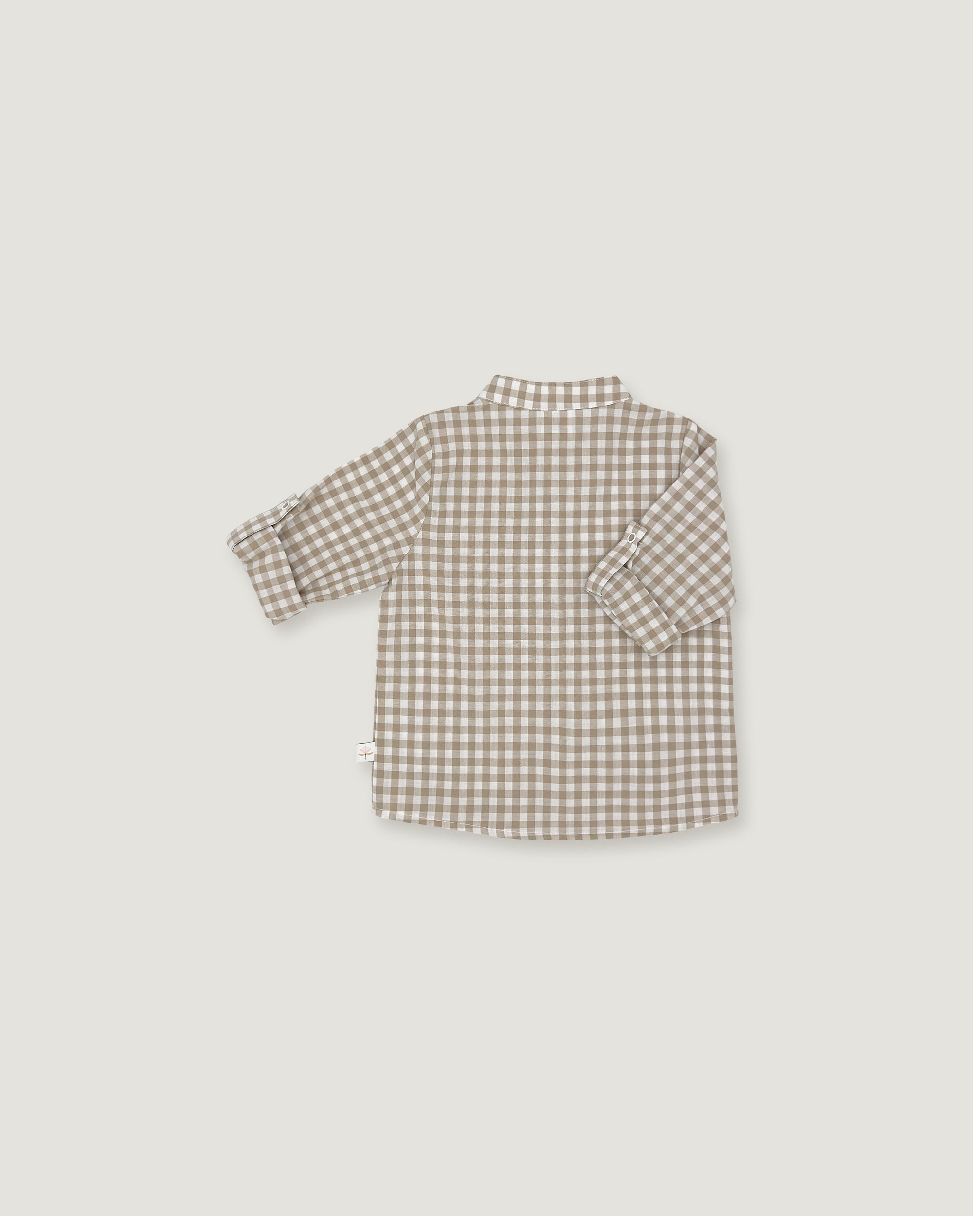 A children's long-sleeve button-up shirt with a small brown and beige gingham check pattern, shown from the back against a light gray background.