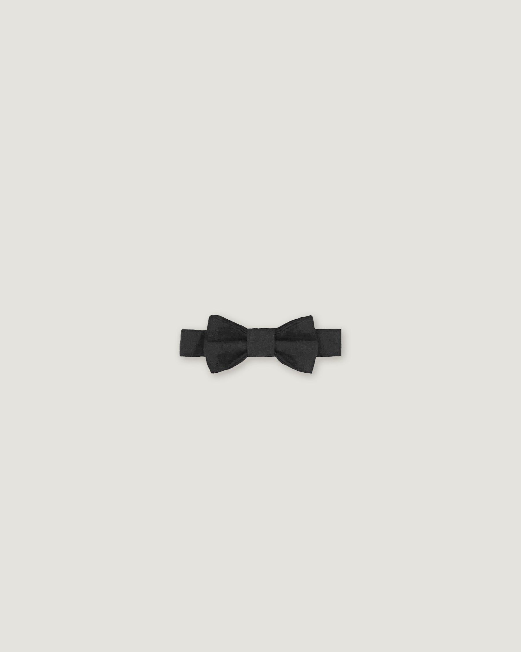 Black bow tie made of linen on a white background
