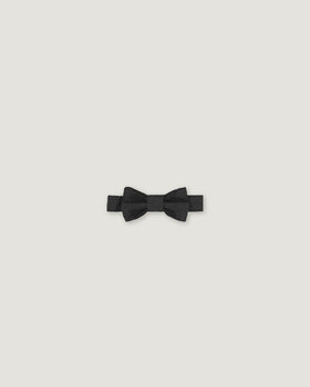 Black bow tie made of linen on a white background