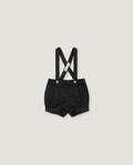 Black baby boy's suspenders shorts with adjustable shoulder straps and a white brand tag, shown flat on a light gray background.