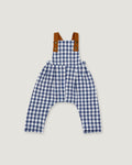 A baby romper in a blue and white gingham pattern with brown shoulder straps, displayed flat against a light gray background.