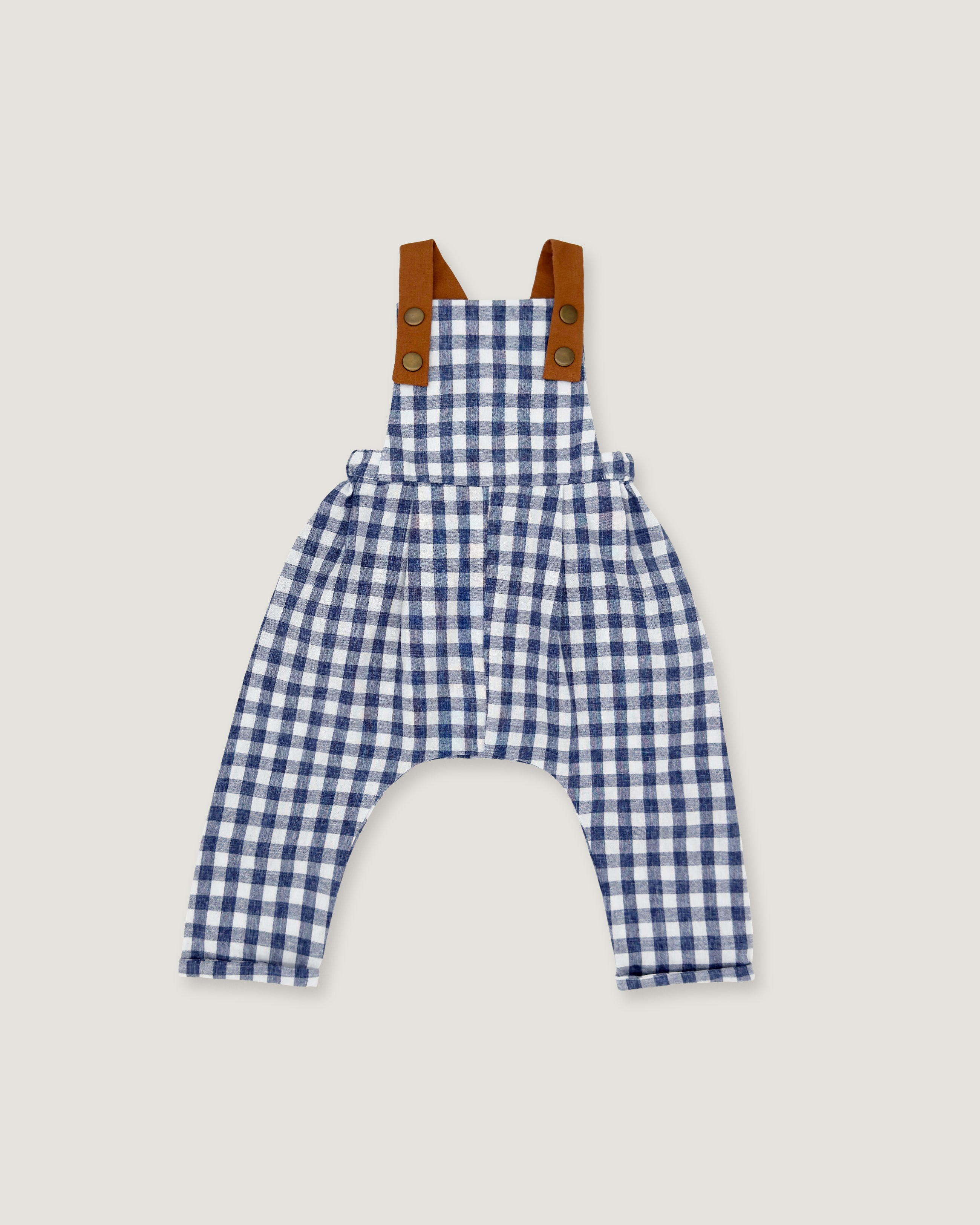 A baby romper in a blue and white gingham pattern with brown shoulder straps, displayed flat against a light gray background.