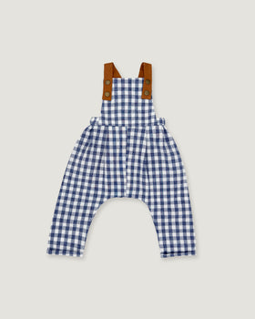 A baby romper in a blue and white gingham pattern with brown shoulder straps, displayed flat against a light gray background.