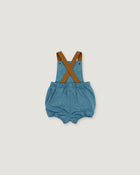 A pair of baby denim bubble shorts with brown suspenders, laid flat on a light gray background.