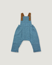 A pair of baby blue denim overall-style pants with brown shoulder straps and brass-tone buttons, shown flat against a light gray background.