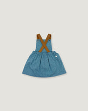 A toddler girl's denim overall dress with brown faux-leather suspenders, shown flat on a light gray background.