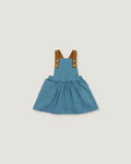 A toddler girl's blue denim overall dress with brown fabric shoulder straps and gold-tone buttons, shown flat on a light gray background.