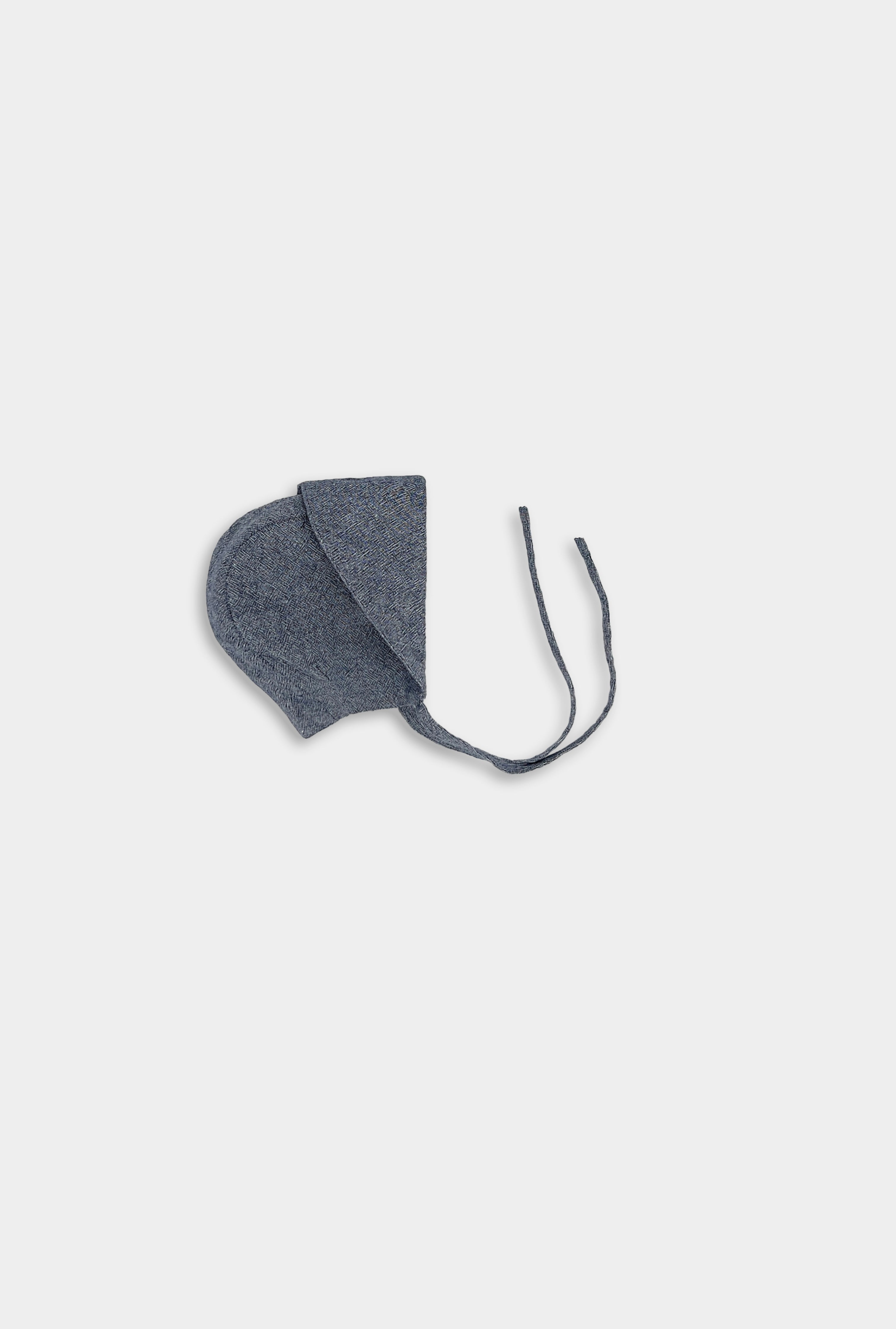 Chambray blue linen sunbonnet with the brim folded backwards, showcasing its timeless design and versatility for summer sun protection.