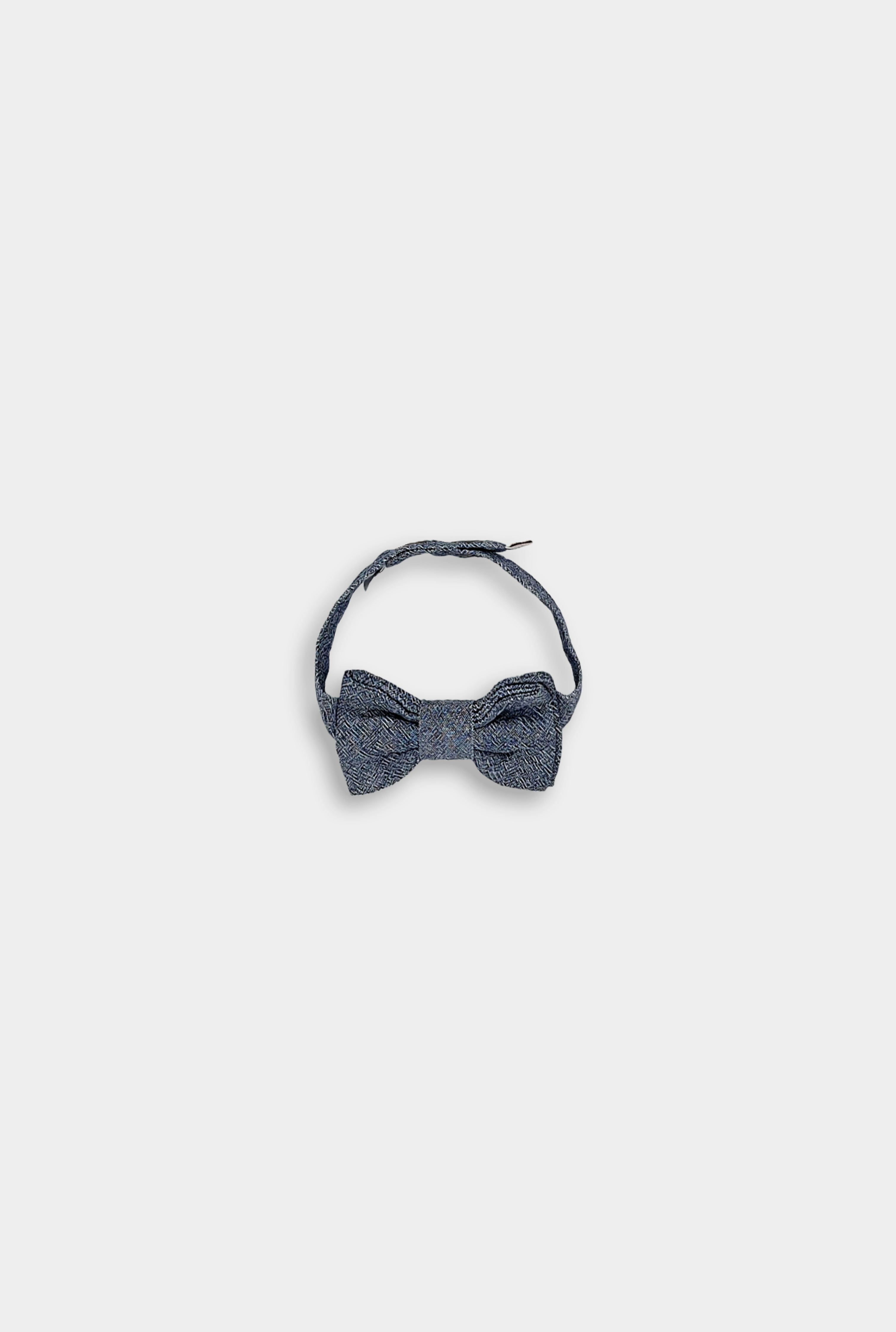Bow Tie with Strap: The Chambray Blue bow tie is displayed alongside its adjustable strap, demonstrating its ease of use and adaptability for different styles, suitable for layering over shirts or wearing on its own.