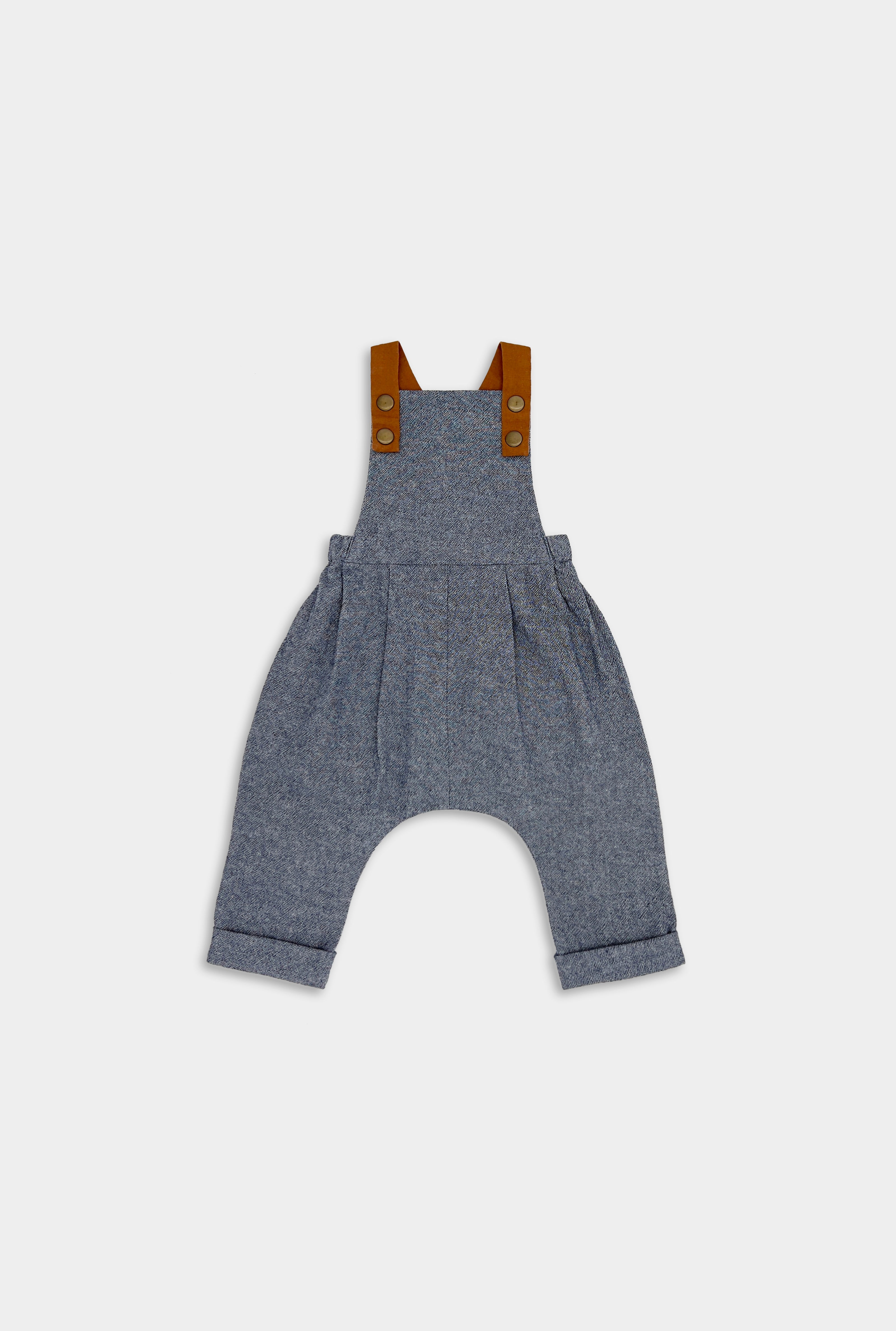 Product Front View of Chambray Blue Long Overalls: A front view of the Chambray Blue Linen Long Overalls, highlighting their classic denim look, stylish pleats, and leather-looking straps that enhance both durability and visual appeal.