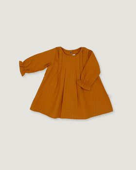 A long-sleeve mustard orange dress with pleated details and ruffled cuffs, laid flat on a light gray background.
