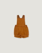 A toddler's short overall romper in a warm camel brown color, laid flat against a light gray background.