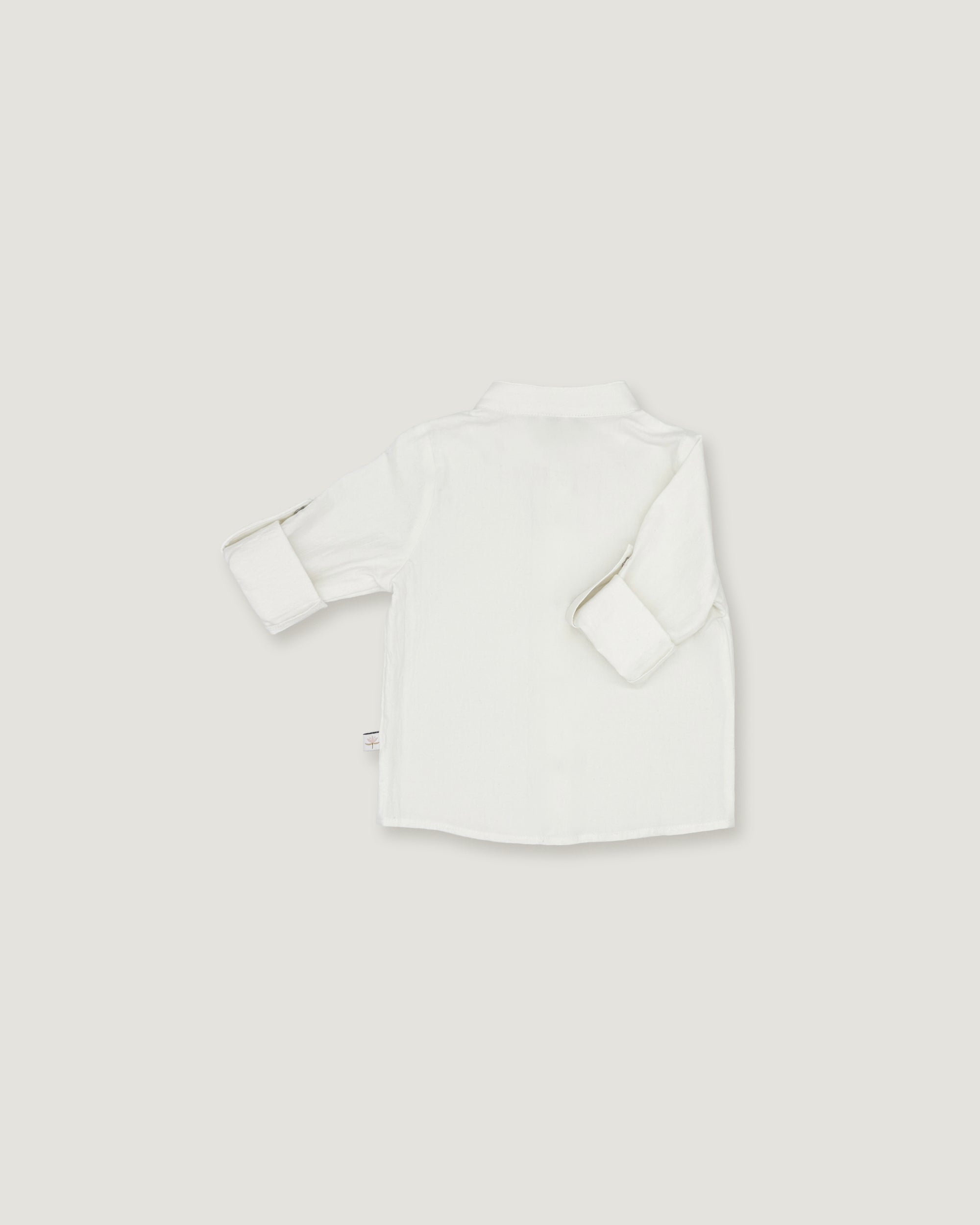 A white long-sleeve button-up shirt shown from the back, laid flat on a light gray background.