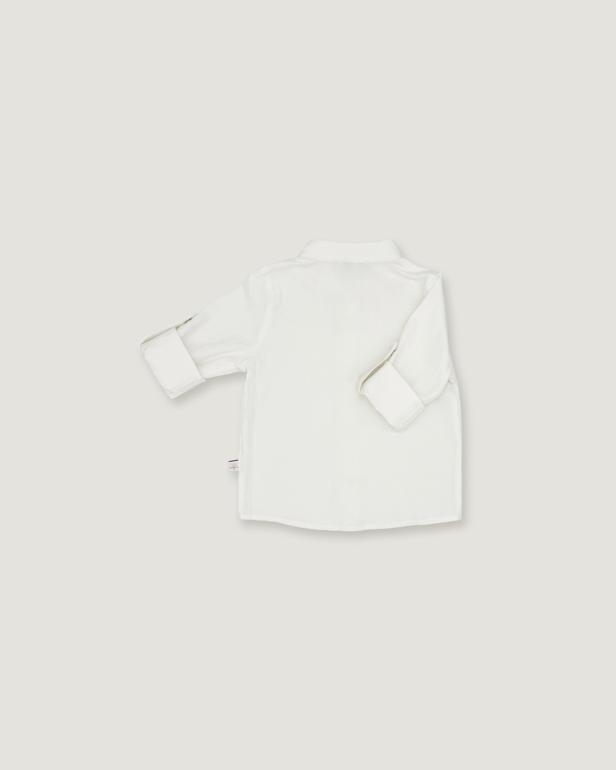 A white long-sleeve button-up shirt shown from the back, laid flat on a light gray background.