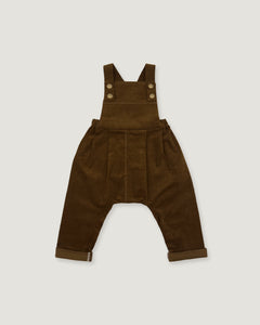 A pair of dark brown corduroy baby overalls with adjustable shoulder straps and four decorative buttons, laid flat against a light gray background.