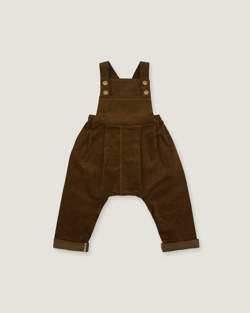 A pair of dark brown corduroy baby overalls with adjustable shoulder straps and four decorative buttons, laid flat against a light gray background.