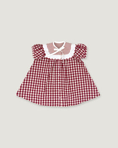 A toddler girl's dress featuring a red and white gingham pattern, a white ruffled collar with a striped inner lining, and puffed sleeves, shown flat on a light gray background.