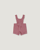 A red and white gingham check baby romper with shoulder straps, laid flat on a light gray background.