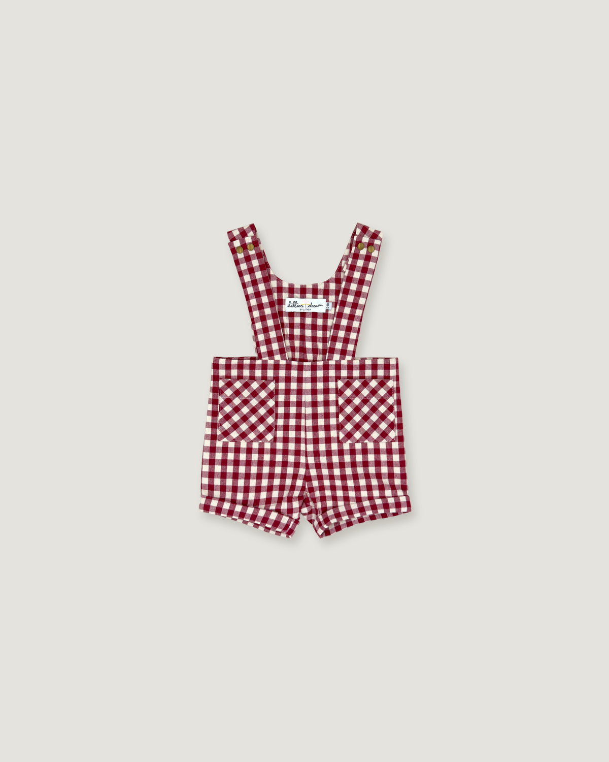 A baby romper in a red and white gingham check pattern, featuring adjustable shoulder straps and front patch pockets, displayed flat against a light gray background.