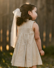 girl in a beige striped dress from the back