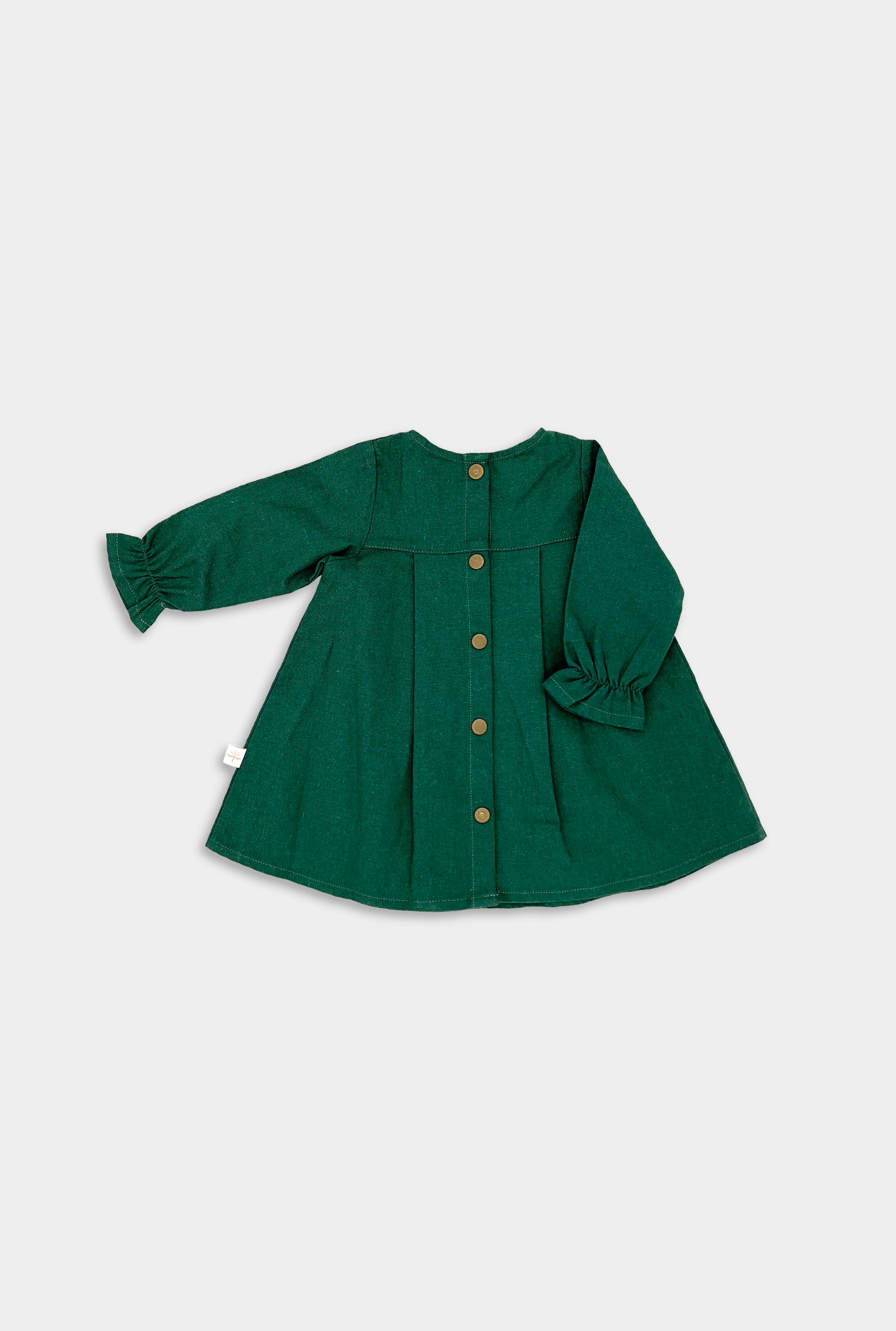 Back view of the evergreen linen dress displayed on its own, emphasizing the quality craftsmanship and elegant design that make it a timeless choice for little girls.