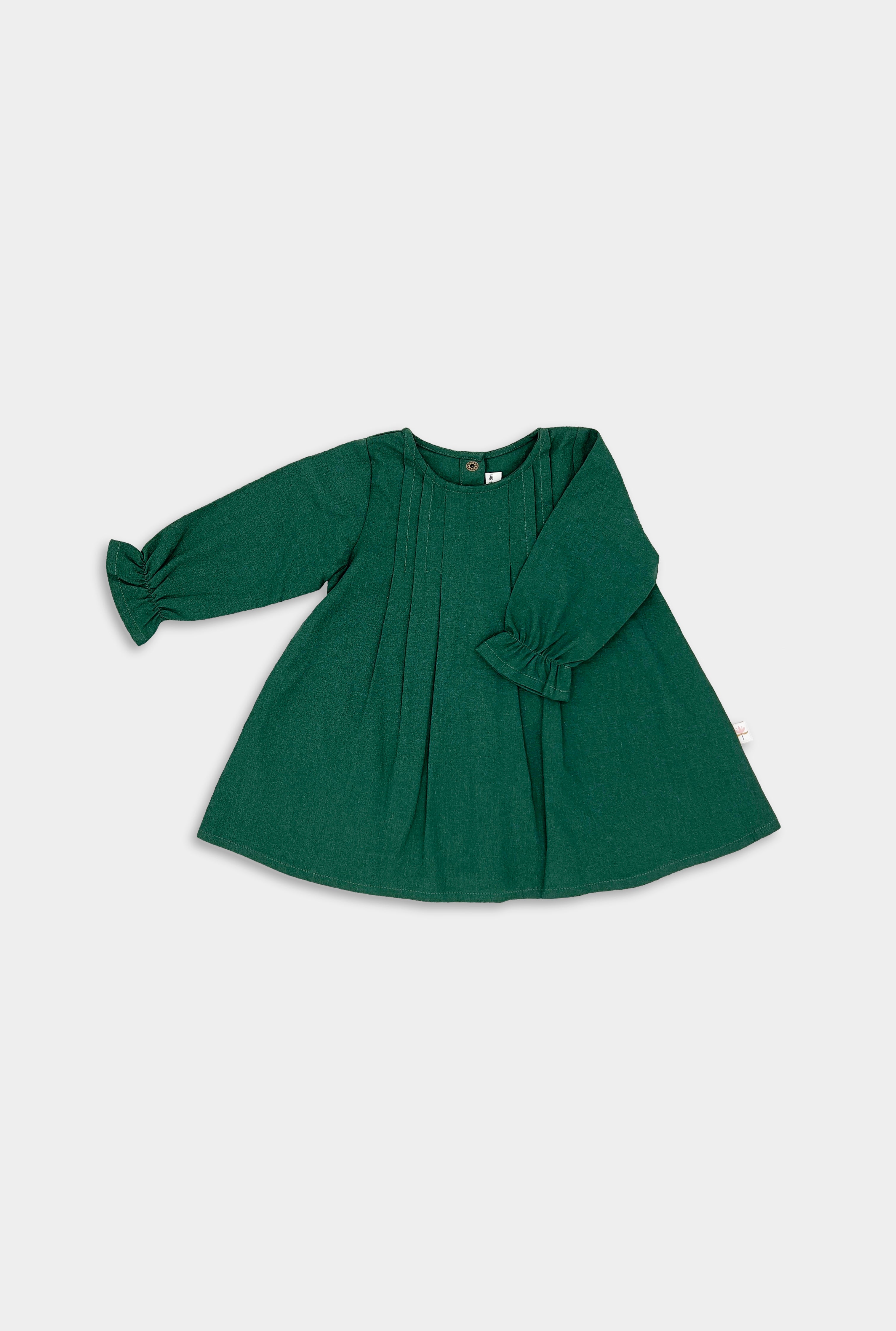 Front view of the evergreen linen dress, showcasing the vibrant hue and chic minimalist design with pin-tucked details that add sophistication.