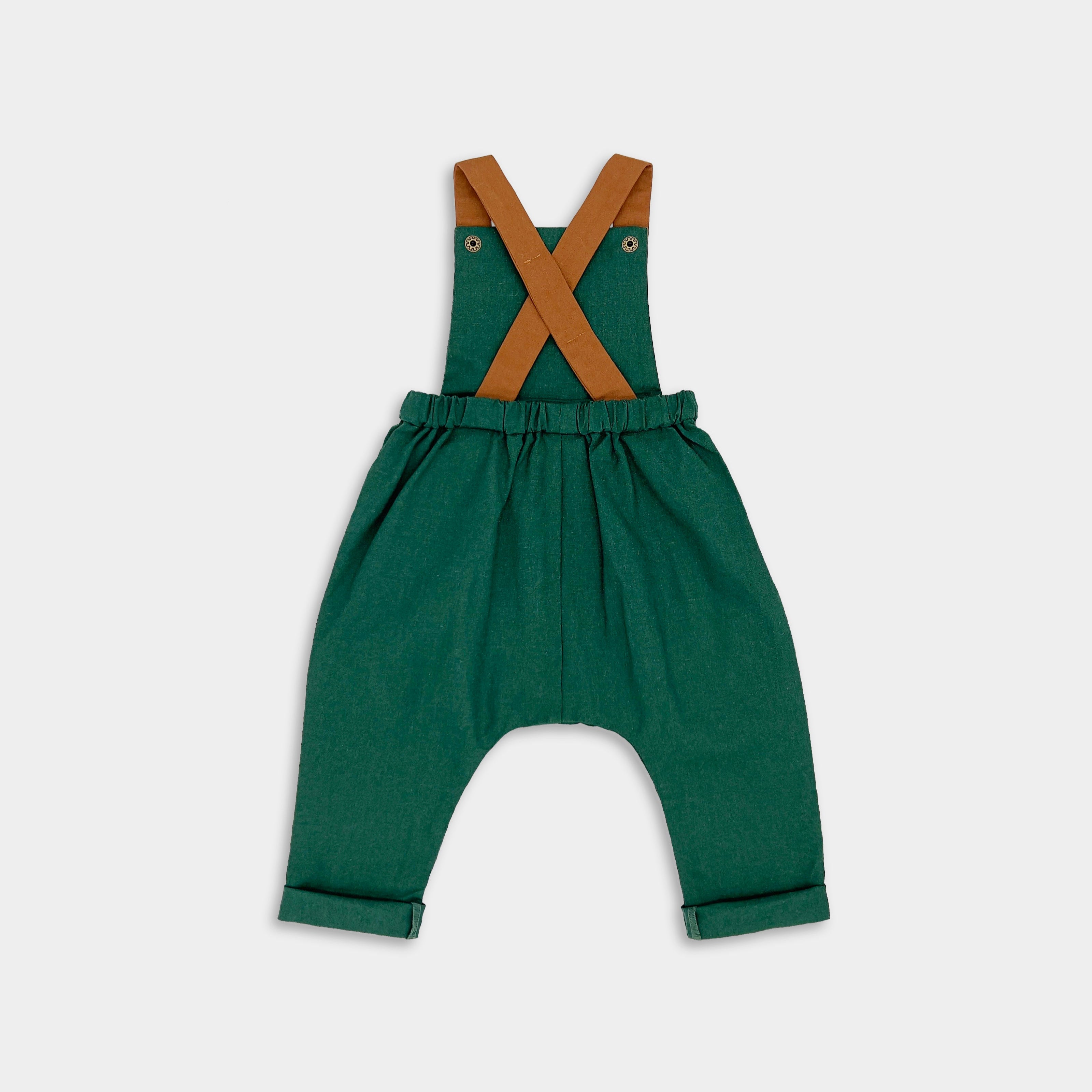  Back view of evergreen linen long overalls displayed on their own, emphasizing the quality craftsmanship and stylish design that make them perfect for passing down.