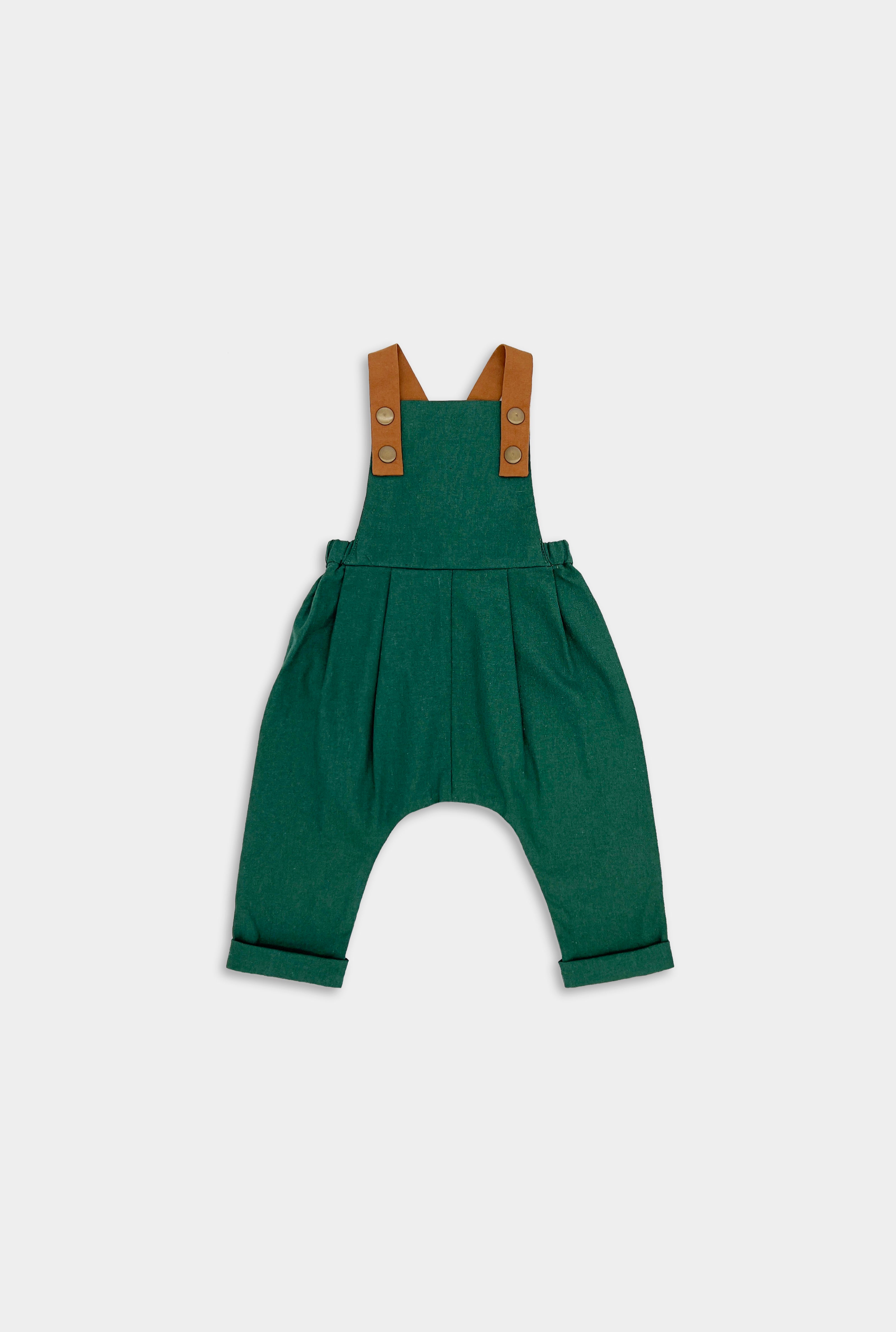 Front view of evergreen linen long overalls, showcasing the stylish pleats and leather-looking straps that enhance both durability and visual appeal.