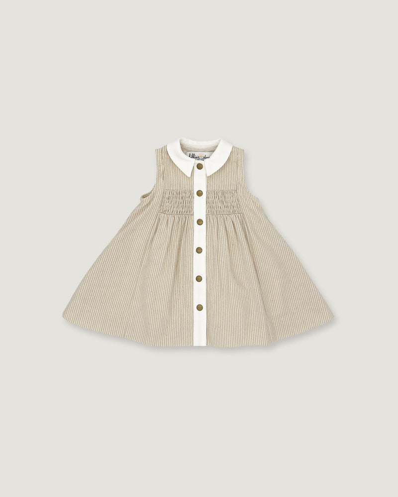A sleeveless baby dress in beige and white vertical pinstripes, featuring a white Peter Pan collar, a smocked bodice, and a front button closure with gold-tone buttons, shown flat on a light gray background.