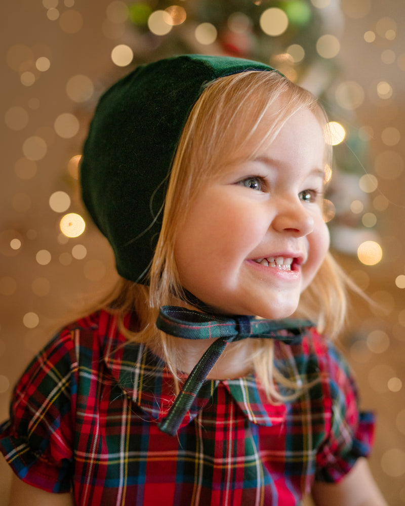 Girl in green bonnet smiling