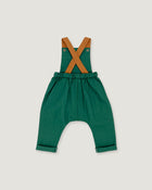 A toddler's green harem-style romper with tan shoulder straps, shown flat on a light gray background.
