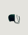 Evergreen velvet bonnet seen sideways on a white background