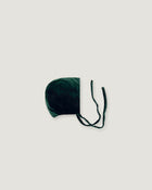 Evergreen velvet bonnet seen sideways on a white background