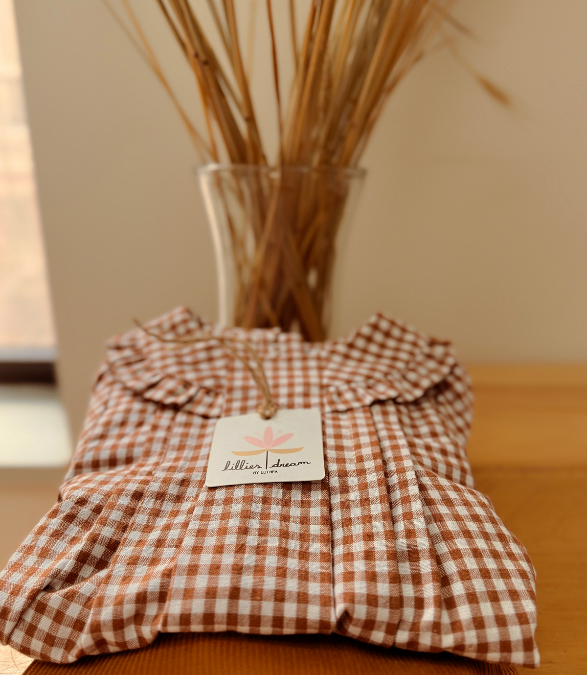 Folded checkered fabric with a tag on a wooden surface