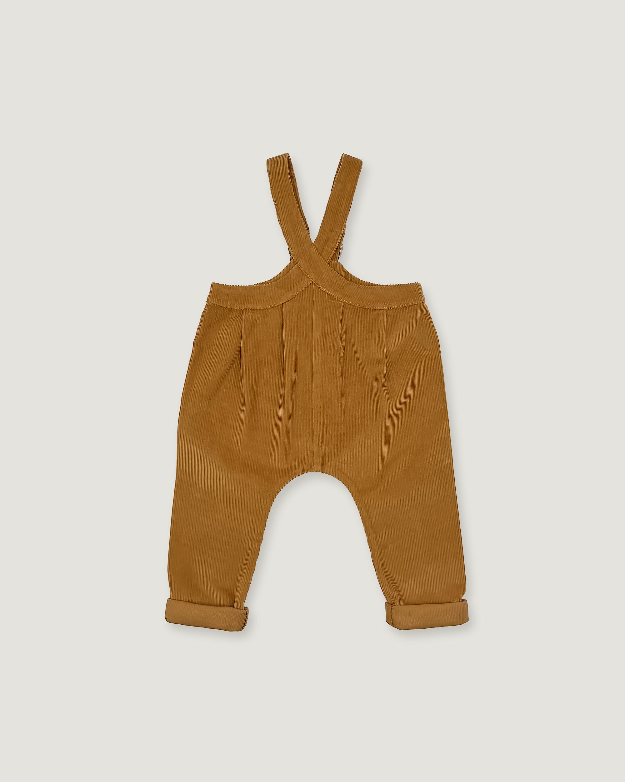 A pair of toddler corduroy overall pants in a warm camel brown color, featuring adjustable shoulder straps and rolled cuffs, shown flat on a light gray background.