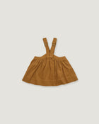 A toddler girl's brown corduroy pinafore dress with adjustable shoulder straps, laid flat on a light gray background.