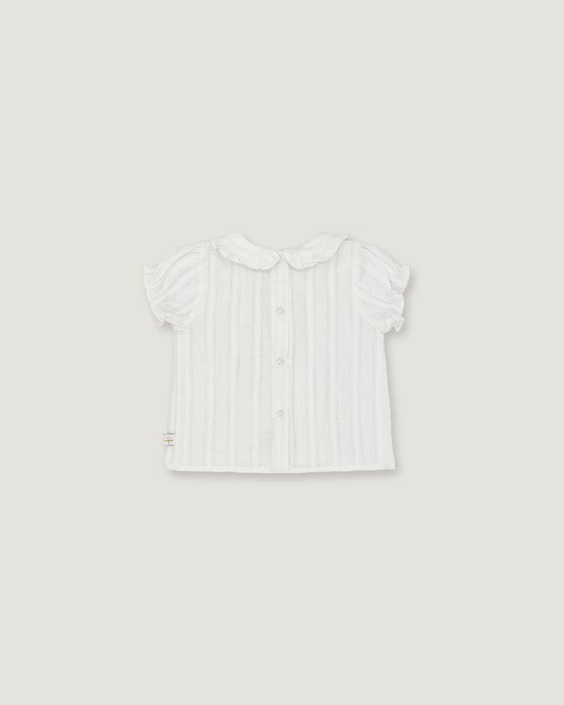 A white short-sleeve baby top with vertical ruffles, a Peter Pan collar, and a button-up front, shown flat against a light gray background.