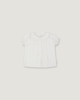 A white short-sleeve baby top with a ruffled Peter Pan collar and subtle vertical pleats, shown flat against a light gray background.