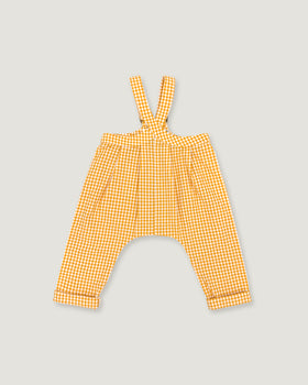 A pair of yellow and white gingham baby pants with shoulder straps, laid flat on a light gray background.