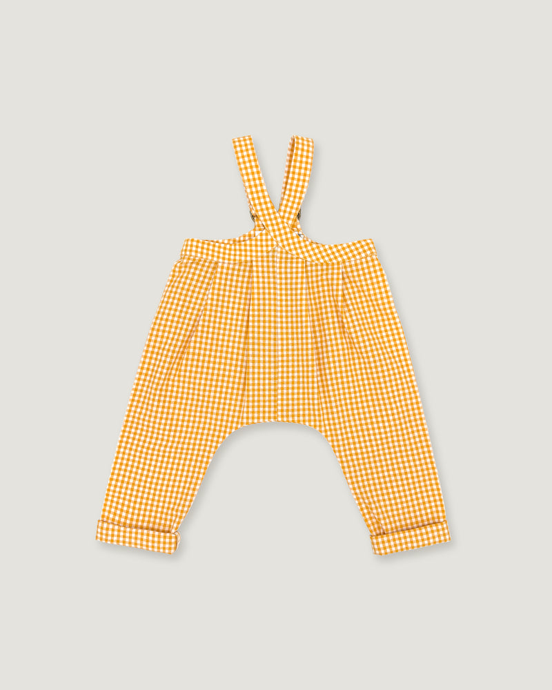 A pair of yellow and white gingham baby pants with shoulder straps, laid flat on a light gray background.
