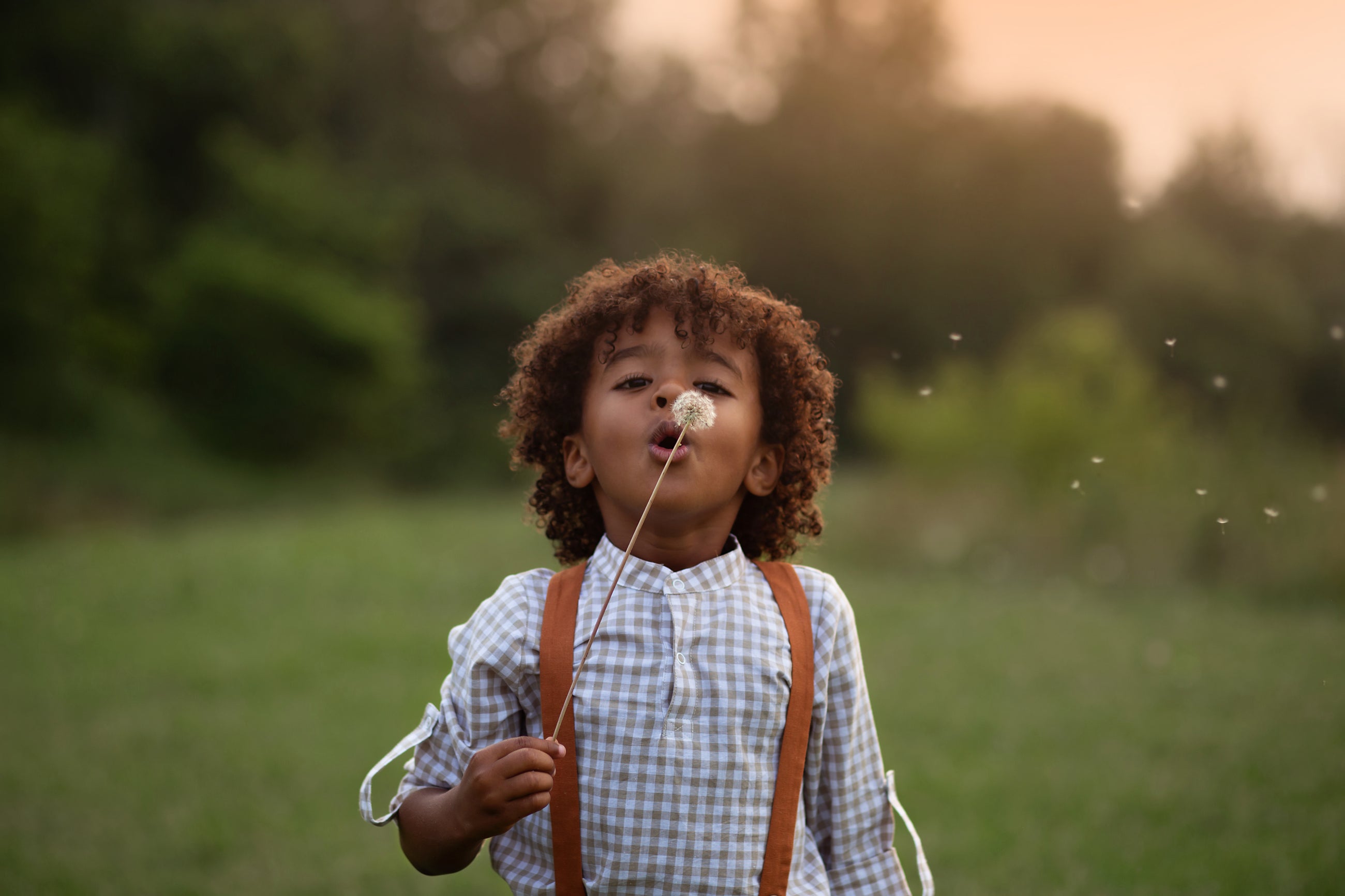 Beige Gingham Henley Shirt worn by 5-year-old boy in size 5Y, featuring a classic Henley placket and 3/4 cuffed sleeves that can be unrolled for layering. Paired with burnt orange linen suspender shorts for a stylish, versatile outfit.