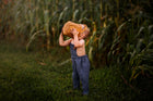 Goofy Pose of Model in Chambray Blue Linen Long Overalls: The model is being silly in the Chambray Blue Long Overalls, illustrating the playful nature of the outfit while emphasizing its comfort and ease of movement.