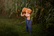 Goofy Pose of Model in Chambray Blue Linen Long Overalls: The model is being silly in the Chambray Blue Long Overalls, illustrating the playful nature of the outfit while emphasizing its comfort and ease of movement.